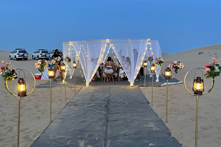 Experience the serene beauty of the UAE desert while enjoying a private BBQ dinner under the stunning dusk sky surrounded by rolling dunes and peaceful landscapes.